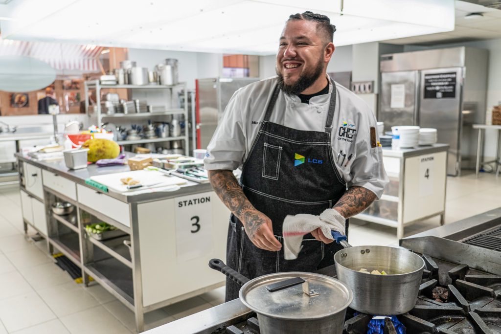 Award winning chef smiling over a boiling pot