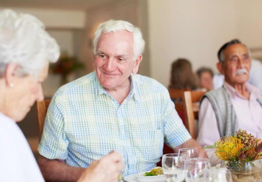 Senior man and woman sitting at dinner