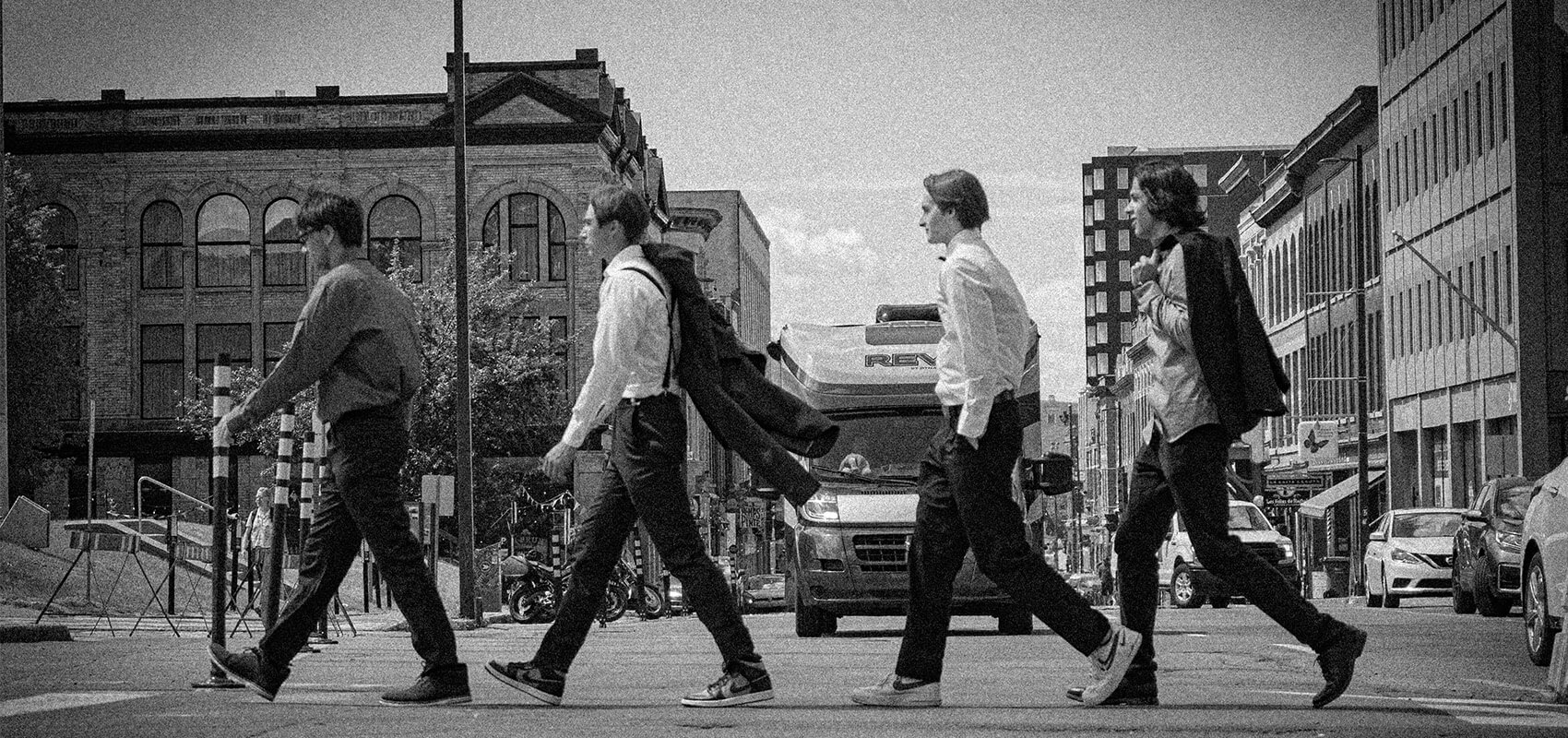 men crossing road